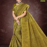 Adorn yourself in timeless artistry with the Florence Varli Chokda saree in earthy mustard olive. Featuring intricate Warli tribal motifs woven across the body and a Bandhani chokda pallu, this saree beautifully blends heritage with elegance