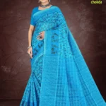 Woman in a vivid sky blue Florence Varli Chokda saree adorned with intricate Warli tribal art and Bandhani chokda checks, styled with a matching blouse and silver oxidized jewelry,