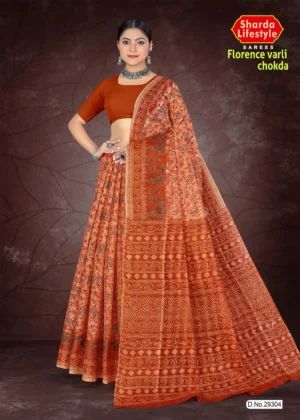 Woman dressed in a burnt orange Florence Varli Chokda saree featuring traditional Warli tribal art and Bandhani chokda motifs, styled with an earthy brown blouse and silver oxidized jewelry