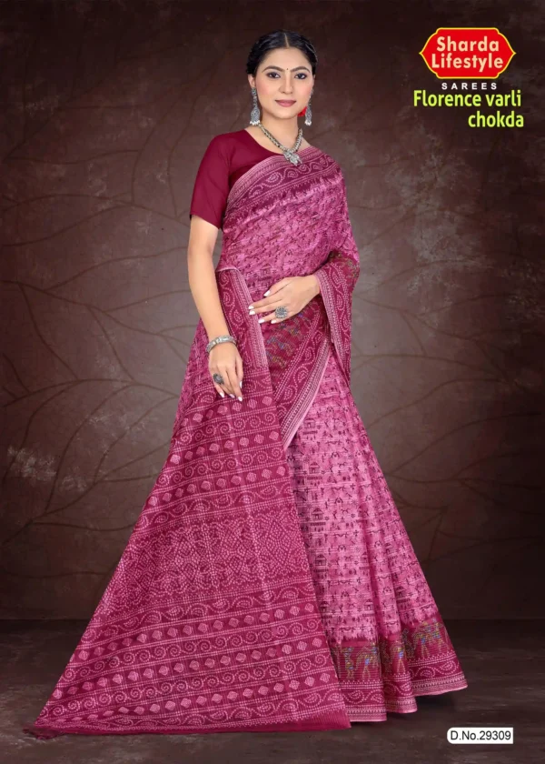 Woman wearing a deep pink Florence Varli Chokda saree by Sharda Lifestyle, featuring intricate traditional prints, a richly detailed pallu, and matching blouse, styled with silver jewelry against a brown textured backdrop.