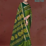 Model draped in deep green and yellow Shaktiman Batick Gold saree featuring batik floral motifs and gold zari border by Sharda Lifestyle