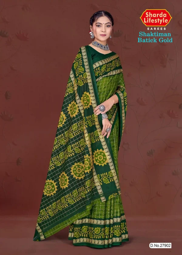 Model draped in deep green and yellow Shaktiman Batick Gold saree featuring batik floral motifs and gold zari border by Sharda Lifestyle