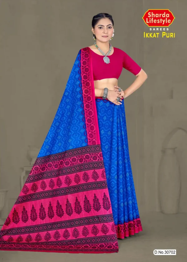 Model wearing Ikkat Puri saree in sapphire blue and rani pink with ikkat weave and bold tribal pallu