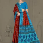 Model wearing rust red and turquoise blue Ikkat Puri saree with intricate traditional motifs, styled with silver jewelry