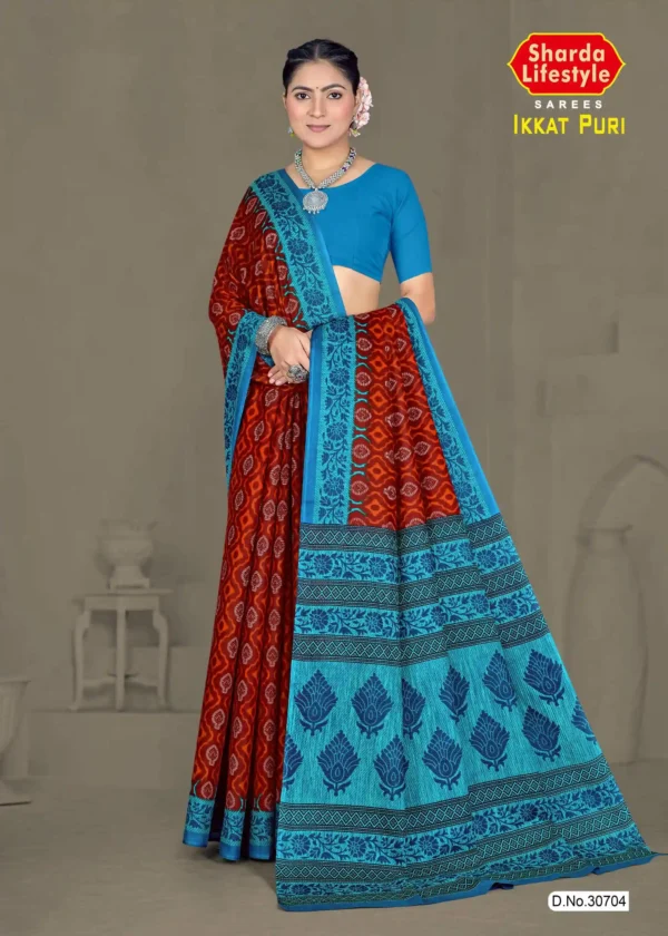 Model wearing rust red and turquoise blue Ikkat Puri saree with intricate traditional motifs, styled with silver jewelry