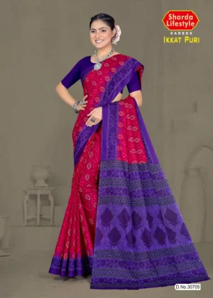 Model wearing a magenta and violet Ikkat Puri saree with bold traditional patterns and temple motif pallu, paired with statement silver jewelry.