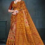 Model wearing copper brown Jayraj Checks saree with golden leaf pallu and multicolor floral printed body from Sharda Sarees