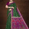 Model wearing a bottle green saree with vibrant magenta pallu featuring folk art, from Sharda Lifestyle’s Singapore Gold – Design No. 30207