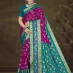 Model wearing purple and teal floral saree with golden zari border from Sharda Sizzling Sona