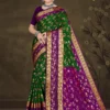 Woman wearing green and purple silk saree with golden zari border from Sharda Sizzling Sona collection