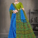 Model wearing a blue and green Sone Pe Shuhaga saree with intricate floral and geometric prints and a matching contrast blouse.